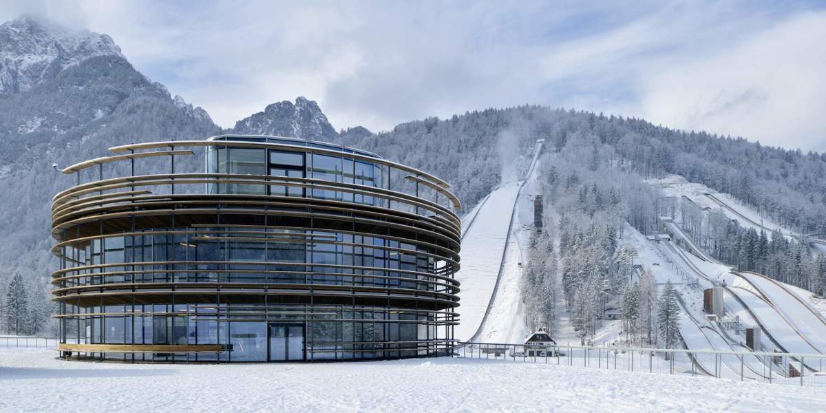 clădirea centrală a Planica Nordic Center cu vedere de la dealurile de sărituri cu schiurile